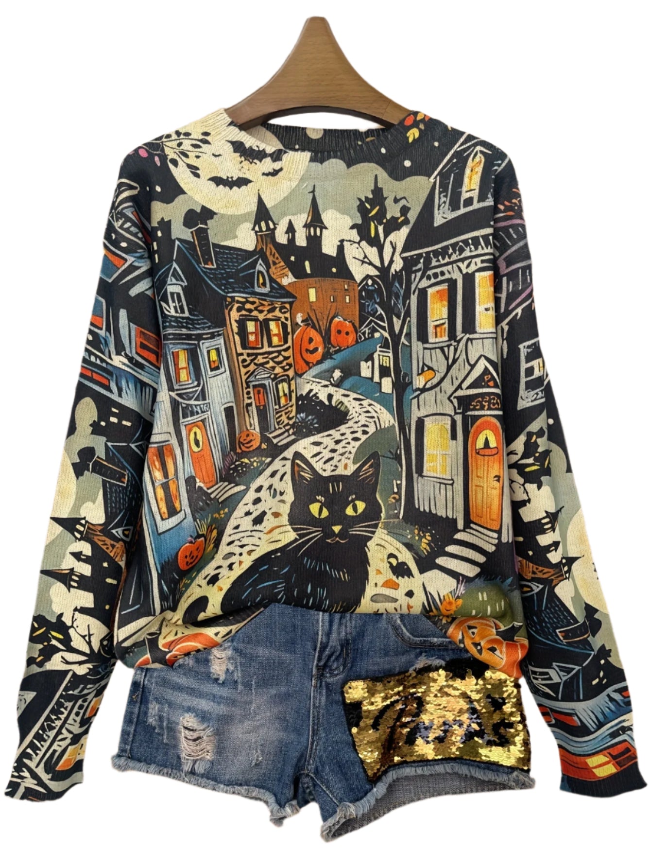 Halloween-themed sweater with a cat design on a wooden background