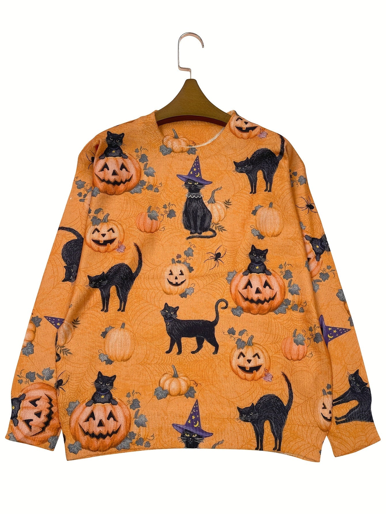Orange sweatshirt with Halloween-themed design featuring pumpkins and black cats on a hanger against a white background.