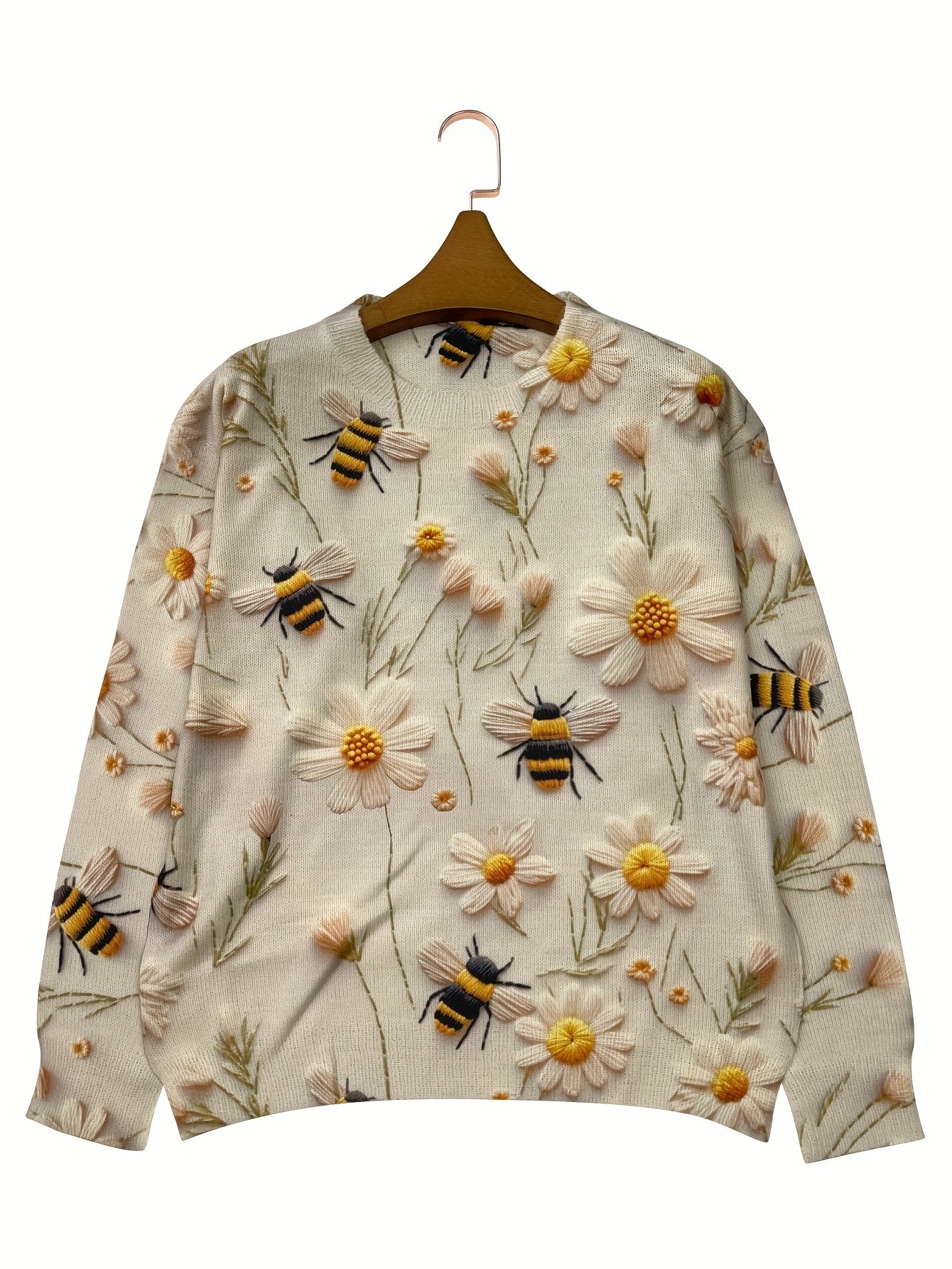 Sweater with bee and flower pattern on a hanger against a white background
