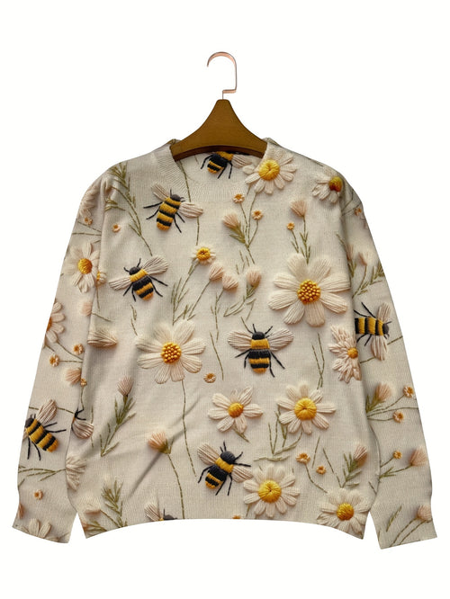 Sweater with bee and flower pattern on a hanger against a white background