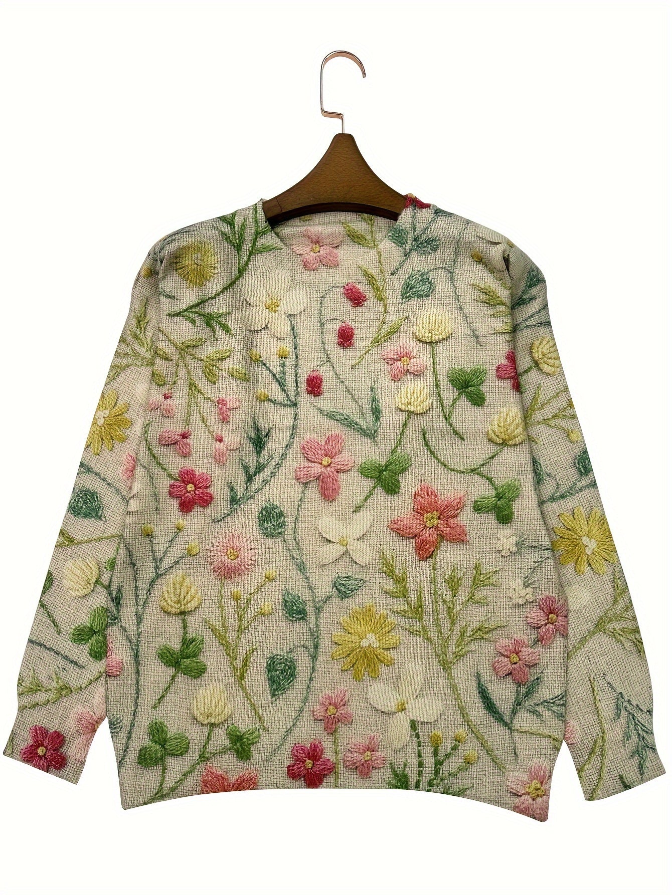 Floral embroidered sweater on a hanger against a white background