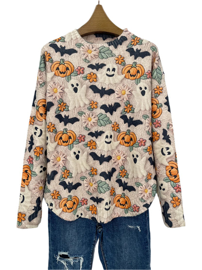 Halloween-themed sweater with pumpkins, ghosts, and bats on a hanger against a dark background.