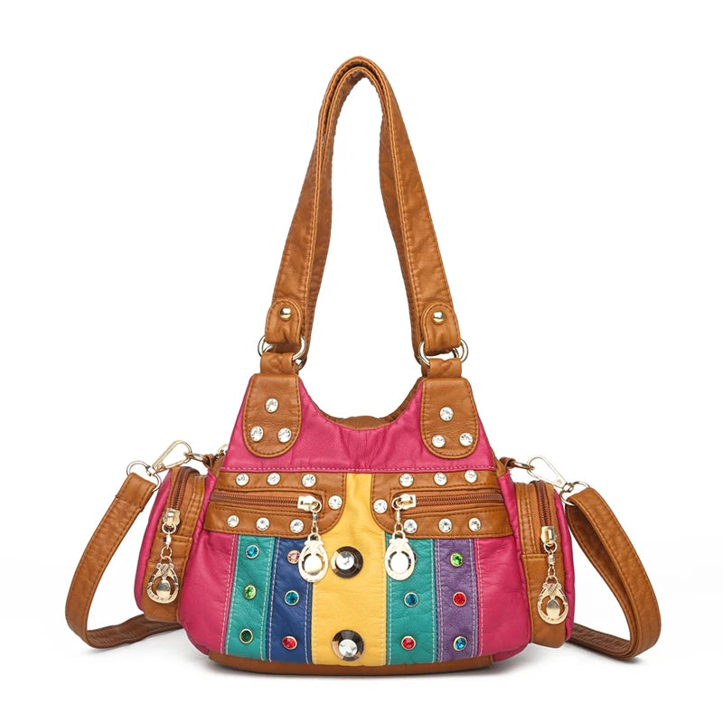 Multicolored handbag with brown handles and strap on a white background