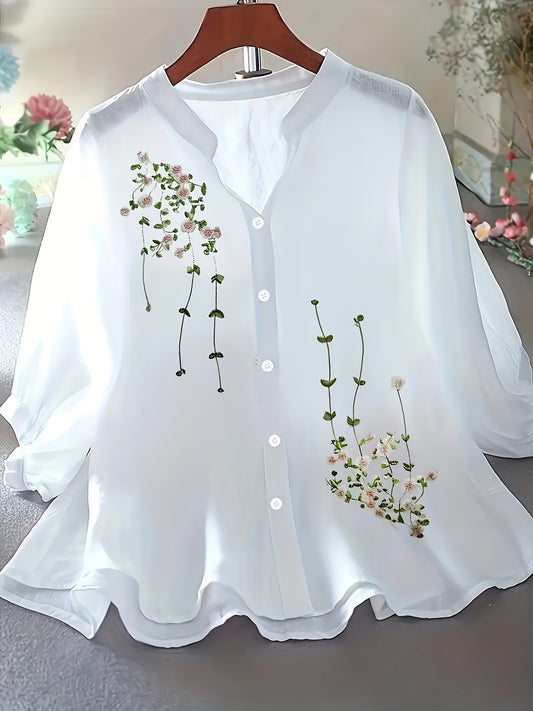 White blouse with floral embroidery on a hanger