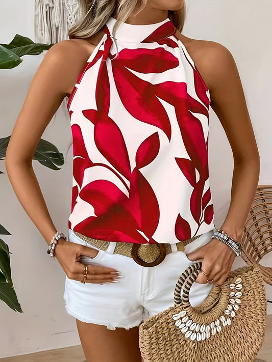 Woman wearing a red and white floral halter top with white shorts, holding a straw bag.