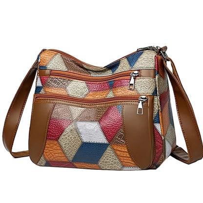 Multicolored patchwork handbag with brown leather accents on a beige background