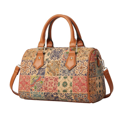 Patterned handbag with brown handles and strap on a beige background, featuring Studio Nyssalie logo.